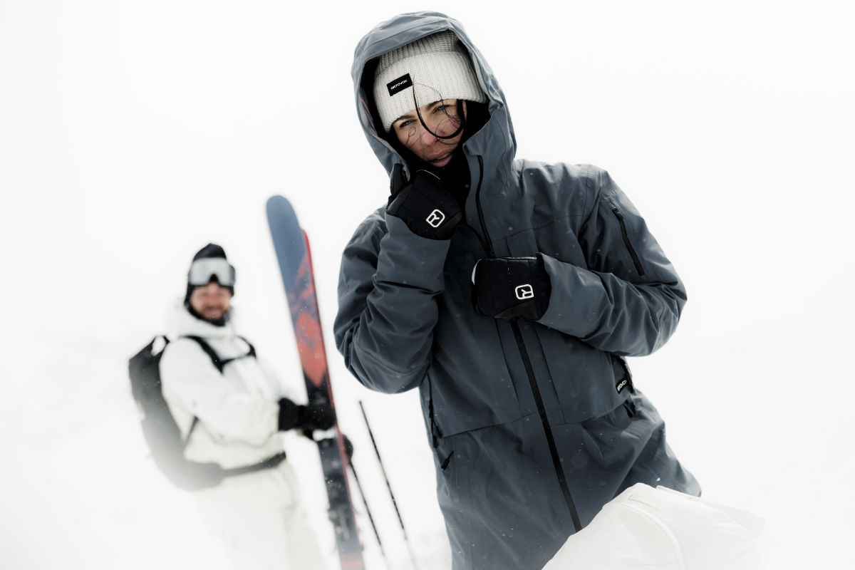 Wintersportler in funktionaler Premium Skibekleidung – hochwertige Skijacke und Handschuhe für extreme Bedingungen