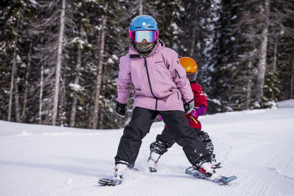 Zwei Kinder in Pflugstellung beim Skifahren – idealer Skischuh für Anfänger mit sicherer Passform