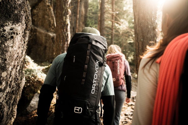 ORTOVOX Wanderrucksäcke – Bergsportladen Frankfurt Wandergruppe mit ORTOVOX-Rucksäcken im Wald – Premium-Ausrüstung aus dem Bergsportladen Frankfurt